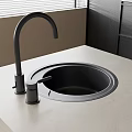 Modern Black High Arc Kitchen Faucet With Black Sink On Light Countertop
