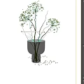 Slender Stemmed Green Leaf Sprigs in Green Textured Vase Against Light Colored Wall Background