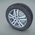 Car Tire With Black Tread Pattern And Silver Alloy Rim Design