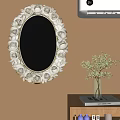 Elegant Oval Mirror With White Gold Rose Carved Frame And Green Plant On Wooden Cabinet