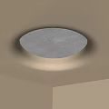 Modern Ceiling Design Featuring Circular Textured Light Fixture With Warm Illumination Installed In Room Corner