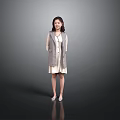 Smiling Woman In Gray Plaid Coat And White Dress Standing Against Gray Background