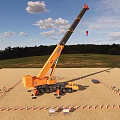 Orange Mobile Crane Lifting Load At Urban Construction Site With Traffic Cones
