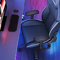 Black Leather Gaming Chair With White Stitching Adjustable Armrests Footrest And RGB Lighting