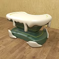 Unique Design Stool With Green Base White Top And Dripping Details On Wooden Floor