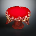 Red Round Tablecloth With Golden Patterns And Sparkling Decorations On Wooden Table