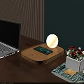 Round Table Lamp On Wooden Tray With Phone Charging Laptop And Flower Pot On Desk