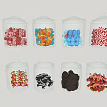 Transparent Glass Cups Filled With Colorful Candies In Various Shapes And Hues