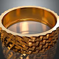 Golden Ring Shaped Household Item With Intricate Braided Surface Design