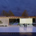 Modern Outdoor Entrance Gate Design With Night Lighting Surrounding Trees Paved Plaza And Parked Car