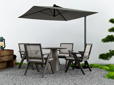 Outdoor Table With Chairs and Umbrella in Gravel Area Decorated With Green Plants 3d model