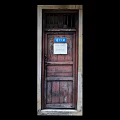 Vintage Old Wooden Door With Blue Sign And Weathered Frame