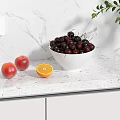 Fresh Cherries in White Bowl with Peaches and Sliced Orange on Marble Countertop