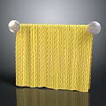 Yellow Knitted Towel Hanging On Towel Rack With Silver Ball Ends