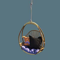 Cozy Rattan Hanging Chair With Round Design And Soft Purple Black Orange Cushions