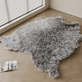 Gray Furry Shaped Rug On Wooden Floor With Open Magazine And Window Blinds