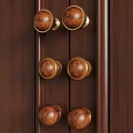Wooden Cabinet Door Knobs With Gold Metal Accents On Dark Wood Surface