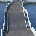 Bridge Featuring Gray Pavement White Railings and Steps Over Blue Water 3d model