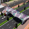 Modern Pedestrian Bridge Featuring Colorful Striped Mesh Design Over Road with Vehicles and Greenery