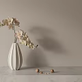 Bonsai Potted Plant With Light Colored Orchids In White Vase On Marble Countertop And Walnuts