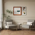 Gray Accent Chairs With Metal Armrests Small Round Table Books Beige Wall Framed Artworks
