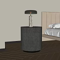 Modern Bedside Table with Brushed Metal Finish and Table Lamp Next to Upholstered Bed