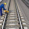 Industrial Railway Track Maintenance Equipment Being Used By Worker On Rail Line