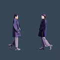 Two women wearing dark colored coats and gray pants walking in stylish outfit