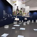 Art Exhibition Space With Large Mural Sculptures And Book Shaped Installations