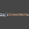 Ancient Weapon with Worn Metal Head and Textured Wooden Handle