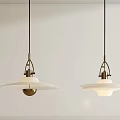 Two Modern Pendant Lights With White Glass Shade And Brass Fixture Hanging From Ceiling