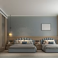 Modern Hotel Guest Room With Twin Blue Beds Decorative Headboards Wall Sconces And Framed Artwork
