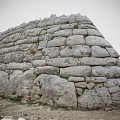 Ancient Stone Wall Ruins Composed Of Stacked Stones Mossy Grass And Base With Dirt Stones
