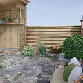 Courtyard Garden With Wooden Fence Stone Wall Patio Green Shrubs Purple Flowers And Outdoor Furniture