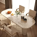 Modern Oval Dining Table Set With Marble Tabletop Beige Chairs Fruit Bowl And Flower Vase