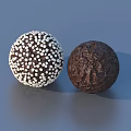 Sweet Chocolate Spheres With White Sprinkles And Dark Brown Textured Surface