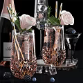 Elegant Pink Champagne Bottle And Crystal Wine Glasses With Ice Cubes Roses And Blackberries