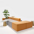 Modern Public Seating With Orange Gray Cushions Green Plant And Side Tables