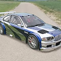 Modified Sports Car with Blue Green Camouflage Large Rear Spoiler Silver Wheels on Country Road