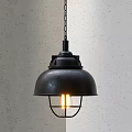 Black Metal Pendant Light With Dome Shade And Cage Lit Bulb Against Gray Textured Wall