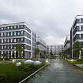 Modern Industrial Plant Building Complex With Landscaped Greenery Roads And Street Lamps