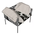 Single Sofa with Black and White Portrait Pattern and White Pillows on Metal Legs