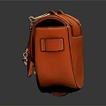 Orange Leather Saddle Bag With Metal Chain Lock Clasp And Textured Surface Design