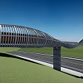 Modern Arched Pedestrian Bridge With Wooden Deck And Concrete Piers Over Green Grassy Landscape