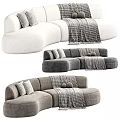Curved Sectional Multi Person Sofa In Brown Gray Plush Material With Decorative Pillows And Throw Blanket