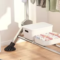 Metal Clothes Rack Hanging Various Colored Clothes With Storage Box On Wooden Bedroom Floor