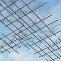 Interconnected Metal Pipes Forming Grid Pattern Against Blue Sky With White Clouds 3d model