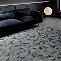 Modern Living Room Featuring Stylish Abstract Patterned Rug Navy Sofa And Round Lamp