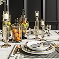 Elegant Golden Dinnerware Set With Black Placemats Candle Holders And Fruit Jars