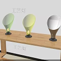 Artistic Craft Table Lamps With Green Yellow White Shades And Black Bases On Wooden Desk